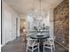 Eat-in kitchen features white cabinets, brick accent wall and modern pendant lighting at 2514 Marshall Pl, Charlotte, NC 28203