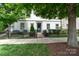 Charming two-story home with a manicured front yard, complemented by a black fence and mature trees at 2514 Marshall Pl, Charlotte, NC 28203
