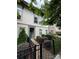Beautiful two-story townhouse with manicured landscaping, a brick walkway, and a secure wrought iron fence at 2514 Marshall Pl, Charlotte, NC 28203