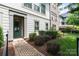 Inviting home exterior features a brick walkway, lush landscaping and a charming green front door at 2514 Marshall Pl, Charlotte, NC 28203