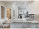 Bright, airy kitchen with gray backsplash, marble countertop, stainless appliances, and decorative lighting fixtures at 2514 Marshall Pl, Charlotte, NC 28203