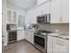 Modern kitchen featuring stainless steel appliances, white cabinetry, wine cooler, and gray subway tile backsplash at 2514 Marshall Pl, Charlotte, NC 28203