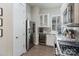 Well-lit kitchen boasts stainless steel appliances, built-in wine cooler, white cabinets, and elegant gray backsplash at 2514 Marshall Pl, Charlotte, NC 28203