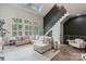 Bright living area featuring modern staircase, neutral furniture, an open floor plan and wood floors at 2514 Marshall Pl, Charlotte, NC 28203