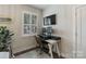This home office features a white desk with two monitors and a leather computer chair at 2514 Marshall Pl, Charlotte, NC 28203