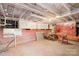 Unfinished basement area with exposed utilities, brick foundation, and storage space at 3515 Back Creek Church Rd, Charlotte, NC 28213