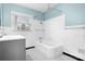 Classic bathroom featuring a tub, black and white tile flooring, and a window for natural light at 3515 Back Creek Church Rd, Charlotte, NC 28213