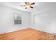 Cozy bedroom with hardwood floors, a ceiling fan, and a closet with sliding doors at 3515 Back Creek Church Rd, Charlotte, NC 28213