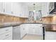 Bright kitchen with white cabinets, granite countertops, tile backsplash, and stainless steel appliances at 3515 Back Creek Church Rd, Charlotte, NC 28213