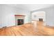 Cozy living room with wood-paneled wall accents, fireplace, and hardwood floors at 3515 Back Creek Church Rd, Charlotte, NC 28213