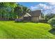 Brick home featuring a deck, screened in porch, and a lush backyard at 3831 Riceland Pl, Charlotte, NC 28216
