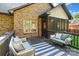 Relaxing covered back porch with comfortable seating and outdoor decor at 3831 Riceland Pl, Charlotte, NC 28216