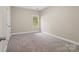 Cozy bedroom with neutral paint, carpet and a large window for natural light at 3831 Riceland Pl, Charlotte, NC 28216