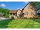 Charming brick home with lush front lawn and manicured landscaping at 3831 Riceland Pl, Charlotte, NC 28216