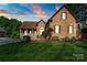 Charming brick home with lush front lawn and manicured landscaping at 3831 Riceland Pl, Charlotte, NC 28216