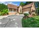 Beautiful brick home with a well-maintained lawn and paved driveway leading to the garage at 3831 Riceland Pl, Charlotte, NC 28216