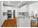 Open kitchen with white cabinets, granite counters, stainless appliances, and a breakfast bar with seating at 3831 Riceland Pl, Charlotte, NC 28216
