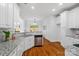 Bright kitchen featuring granite countertops, white cabinets, stainless steel appliances and hardwood flooring at 3831 Riceland Pl, Charlotte, NC 28216