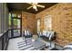 Cozy screened patio with brick accent wall and stylish seating area at 3831 Riceland Pl, Charlotte, NC 28216