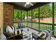 Relaxing screened porch featuring outdoor seating, ceiling fan, and views of the backyard at 3831 Riceland Pl, Charlotte, NC 28216