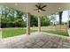 Enjoy outdoor living under this covered patio with a ceiling fan and beautiful backyard views at 408 Ideal Way, Charlotte, NC 28203