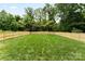 Large, fenced backyard with lush green grass, offering privacy and plenty of space for outdoor activities at 408 Ideal Way, Charlotte, NC 28203