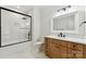 Clean bathroom featuring a glass-enclosed shower, white subway tile, and wood vanity for a modern aesthetic at 408 Ideal Way, Charlotte, NC 28203