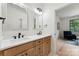 Elegant bathroom featuring dual sinks, wood cabinetry, and modern fixtures for a luxurious and functional space at 408 Ideal Way, Charlotte, NC 28203