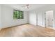 Bright bedroom with hardwood floors, a large window, and white walls, creating a serene and spacious retreat at 408 Ideal Way, Charlotte, NC 28203