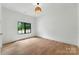 This bright bedroom features hardwood floors and a large window with backyard views at 408 Ideal Way, Charlotte, NC 28203