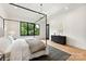 Bright bedroom featuring a four-poster bed, modern decor, and a tranquil view to exterior at 408 Ideal Way, Charlotte, NC 28203