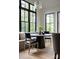 Sunlit breakfast nook boasts a round table, banquette seating, and expansive windows with serene views at 408 Ideal Way, Charlotte, NC 28203