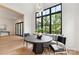 Bright breakfast nook features a round table, bench seating, and a large window overlooking the lush greenery at 408 Ideal Way, Charlotte, NC 28203