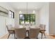 Bright dining room featuring a wooden table, comfortable chairs, and a view of the neighborhood at 408 Ideal Way, Charlotte, NC 28203