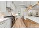 Modern kitchen featuring stainless steel appliances, white cabinetry, and light wood floors at 408 Ideal Way, Charlotte, NC 28203