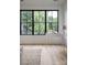 Bright living room featuring large windows, wood floors, and a stylish accent table, perfect for a modern home at 408 Ideal Way, Charlotte, NC 28203