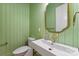 Chic powder room featuring green walls and a unique brass faucet, adding a pop of color at 408 Ideal Way, Charlotte, NC 28203