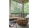 Cozy screened porch features comfortable seating and serene views of the surrounding greenery at 408 Ideal Way, Charlotte, NC 28203