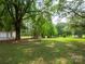Expansive backyard with mature trees offering shade and privacy and a detached garage at 409 Ridge Rd, Clover, SC 29710