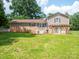Expansive backyard featuring a brick house with a pergola and lush green lawn at 409 Ridge Rd, Clover, SC 29710
