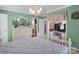 Inviting bedroom featuring a chandelier, dressing table, and an ensuite bathroom at 409 Ridge Rd, Clover, SC 29710