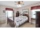 Traditional bedroom with floral wallpaper, a four-poster bed, and plenty of natural light at 409 Ridge Rd, Clover, SC 29710