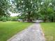 Long driveway leading to a well-maintained home with a spacious front yard and detached garage at 409 Ridge Rd, Clover, SC 29710