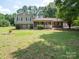 Attractive two-story home with a inviting front porch and manicured lawn on a sunny day at 409 Ridge Rd, Clover, SC 29710