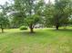 Spacious front yard with mature trees offering a picturesque view of this charming home at 409 Ridge Rd, Clover, SC 29710