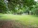 Large front yard with mature trees, offering a serene setting for this lovely home at 409 Ridge Rd, Clover, SC 29710