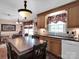 Bright kitchen with wood cabinetry, black countertops, stainless steel appliances and eat-in space at 409 Ridge Rd, Clover, SC 29710