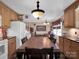 An eat-in kitchen with a long dining table, brown cabinets, and open access to a living room at 409 Ridge Rd, Clover, SC 29710