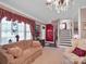 Cozy living room features a patterned sofa and a staircase at 409 Ridge Rd, Clover, SC 29710