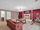 Spacious living room featuring a decorative fireplace, brick accent wall, and neutral carpeting at 409 Ridge Rd, Clover, SC 29710